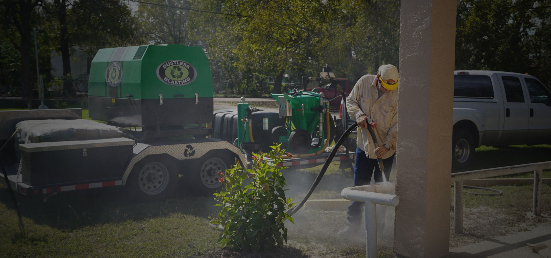 A Dustless Mobile Blasting of Clarksville technician dustless blasting on site next to the mobile Dustless Blasting rig